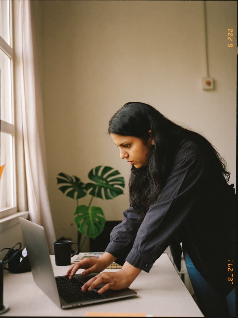 A brand marketer reviews creator content on her laptop